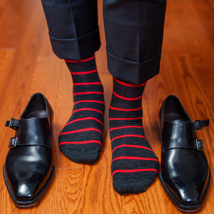man wearing dark grey and bright red striped dress socks with dark grey slacks